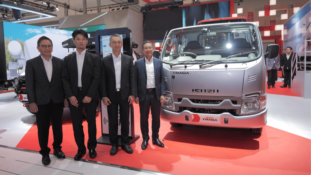 Executives from Isuzu Astra Motor Indonesia pose beside the Isuzu Traga 50th Special Edition pickup truck during its launch at GIIAS 2025 in BSD City.