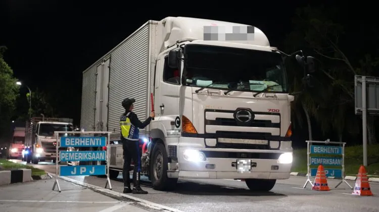 JPJ enforcement personnel monitoring traffic during safety campaign
