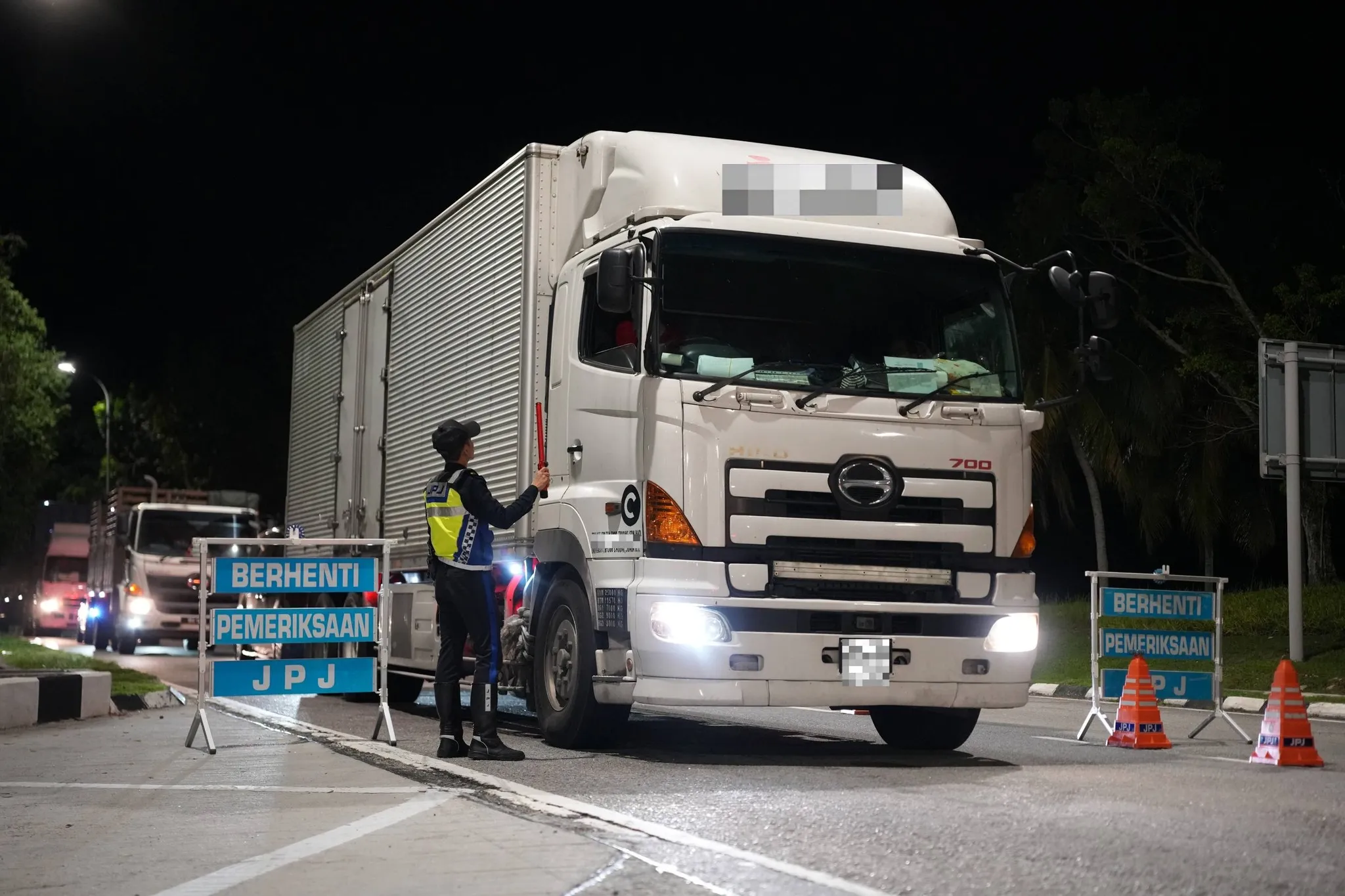 JPJ enforcement personnel monitoring traffic during safety campaign
