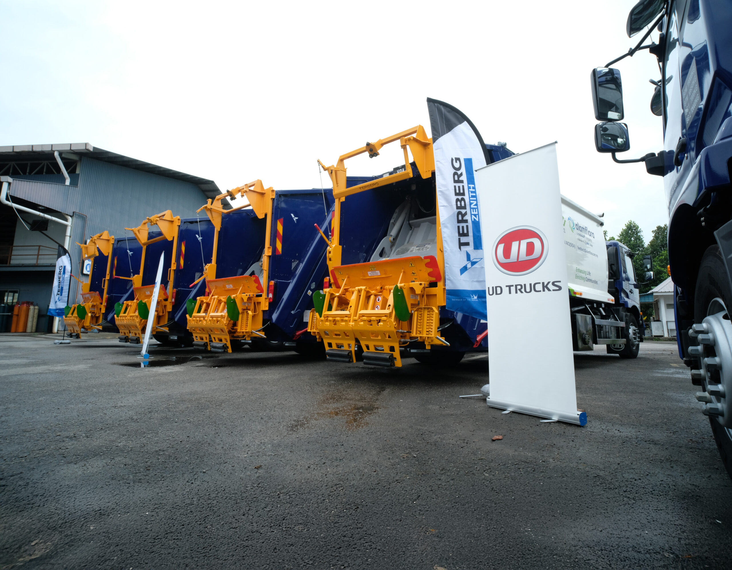A lineup of new UD Croner waste collection trucks featuring Terberg Malaysia rear-loading compaction bodies. Photo/Image Credit: UD Trucks & TCIE